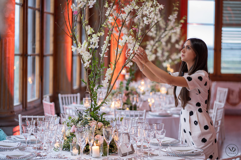 Girl handling flowers on a table