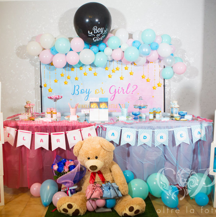 Baby Shower tables with blue and pink balloons and a teddy bear